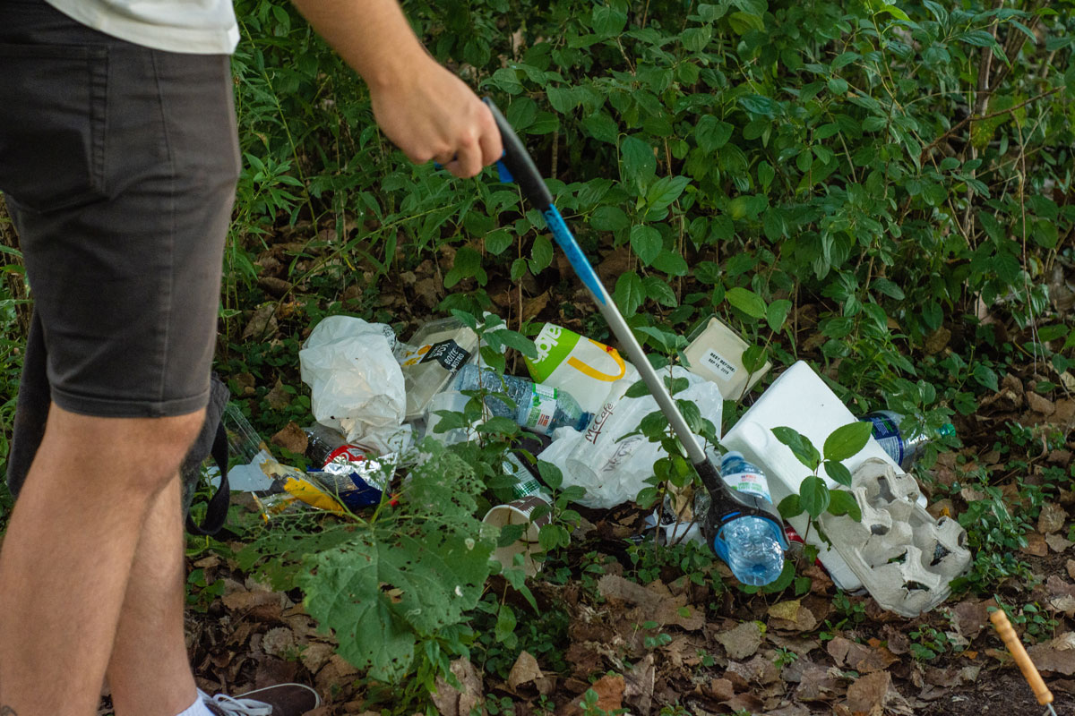 volunteer picks plastic bottle off a pile