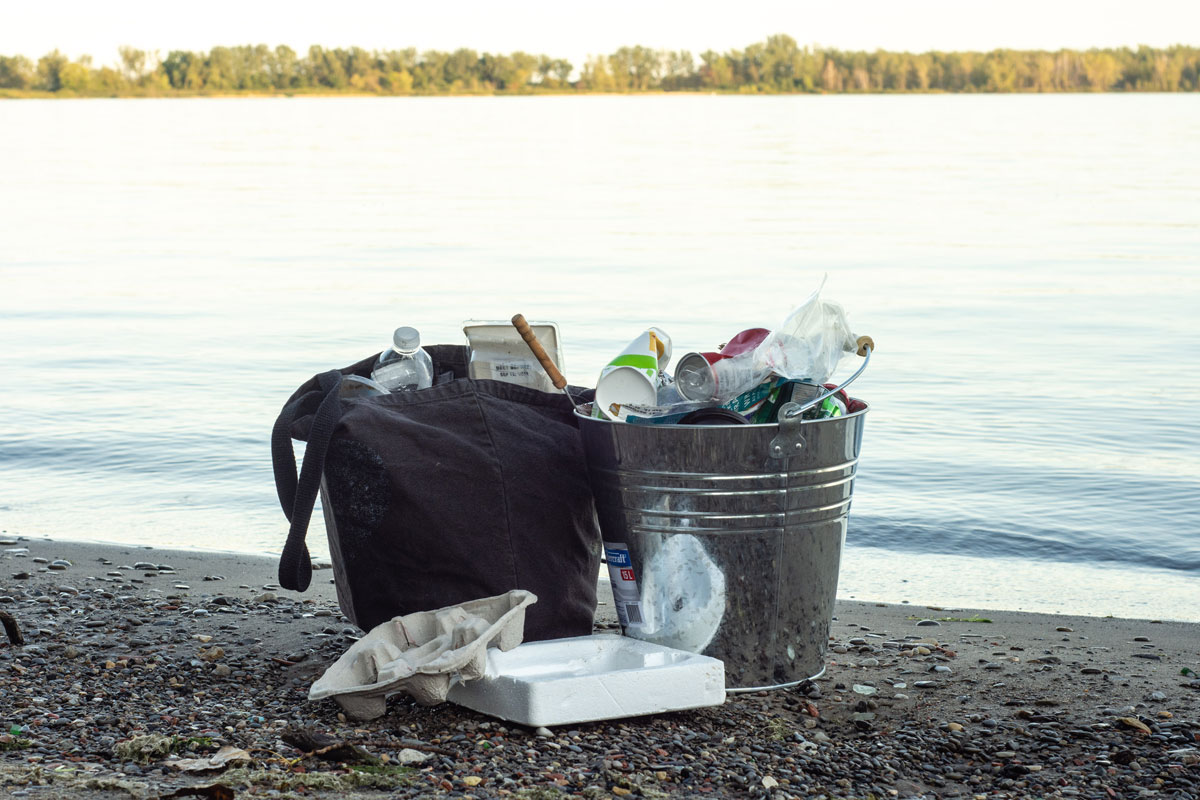 litter in buckets by the beach