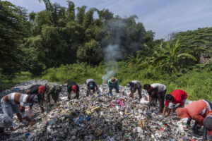 Villagers pick through discarded imported plastic that was dumped there by a nearby paper recycling company whose imported paper was contaminated with plastic, in Sumengko Village, near Gresik, Surabaya, Indonesia on 21st February, 2019.