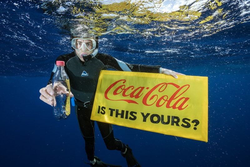 Diver finds a Coca-cola bottle in the ocean