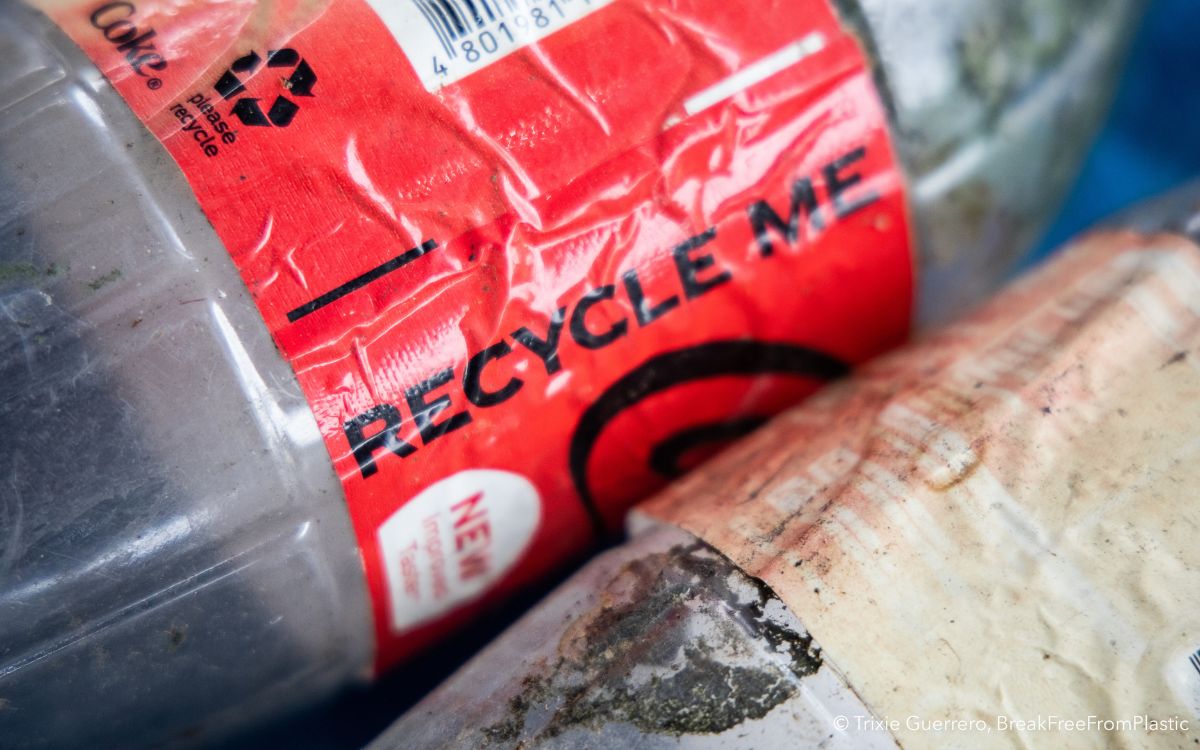 A close-up shot of the recycle me label on the coca-cola bottle