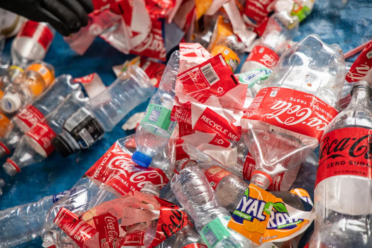 a pile of coca-cola labels with recycle me text